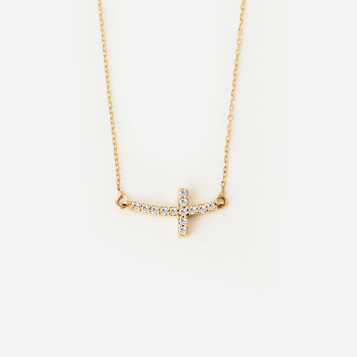 Curved diamond cross necklace made of 585 gold