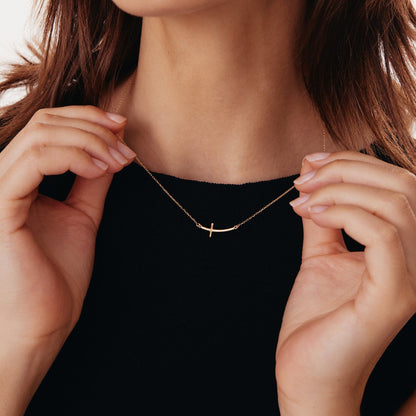 Sideways curved cross necklace made of 585 gold