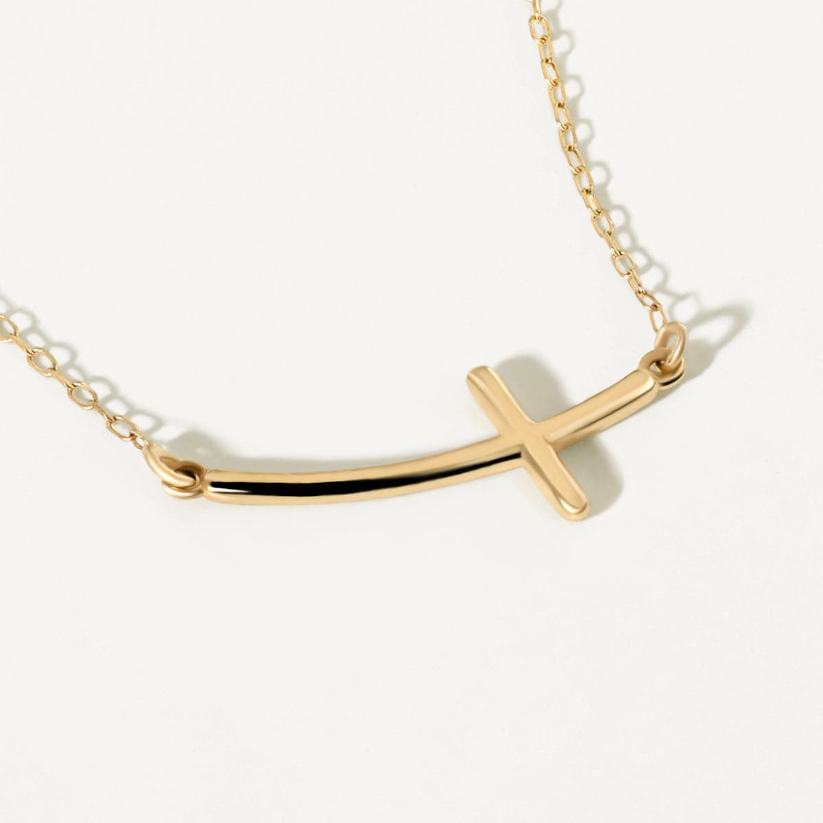 Sideways curved cross necklace made of 585 gold